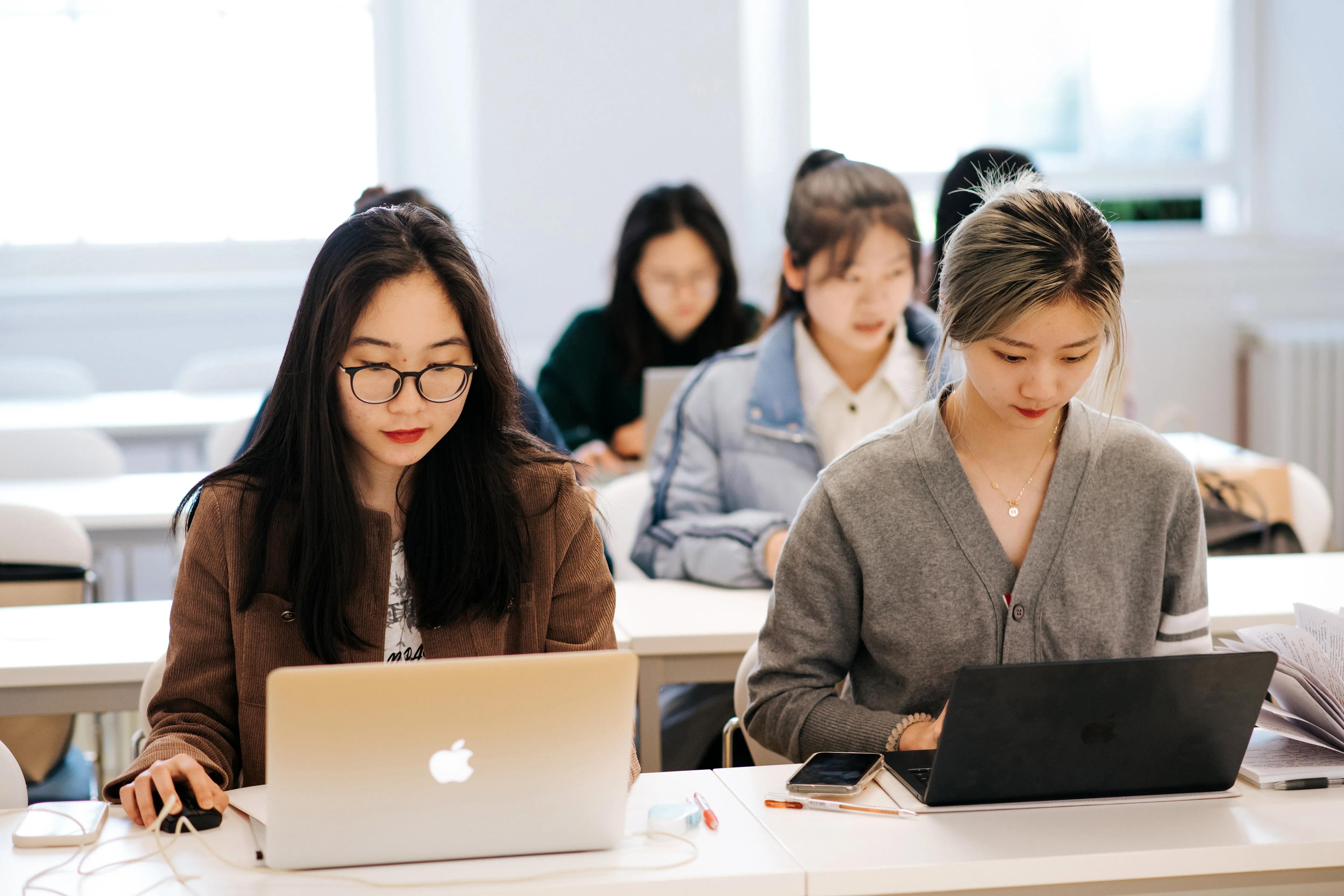 Two students on their laptops