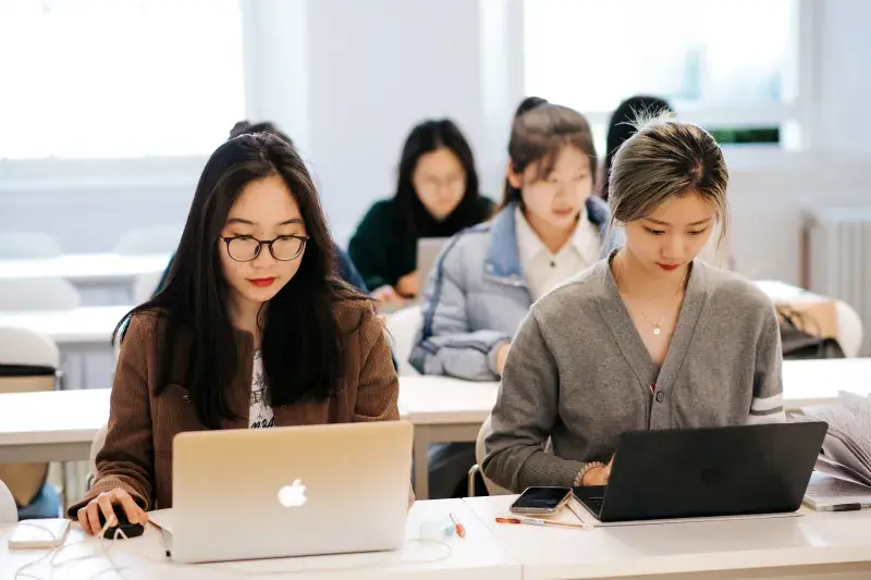 Two students on their laptops